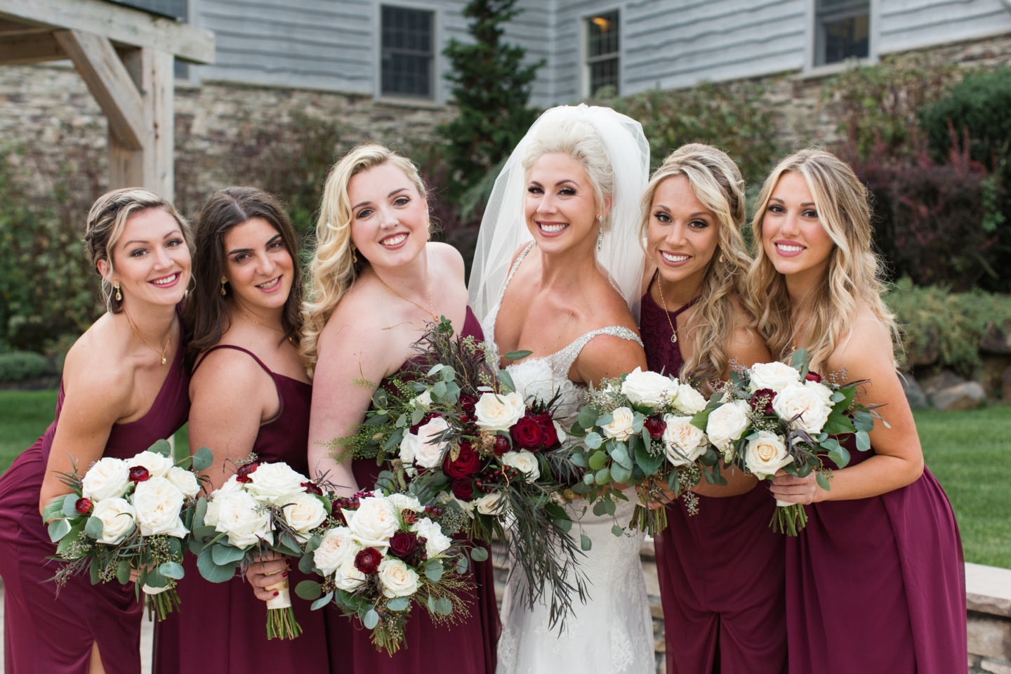 Happy newlywed couple entering reception with elegant bridal hairstyle
